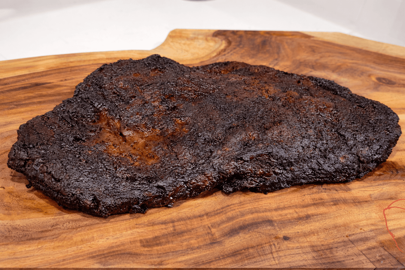 Smoked brisket on a wooden cutting board