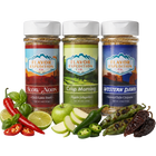 Three jars of Flavor Expedition Co. spices with ingredients like peppers and apples on a white background