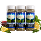 Three jars of Flavor Expedition Tuscan Evening Tangy Herb seasoning with lemons and herbs on a white background.