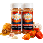 Two jars of Flavor Expedition Volcanic Sunset seasoning with peppers, garlic, and honey on a white background.