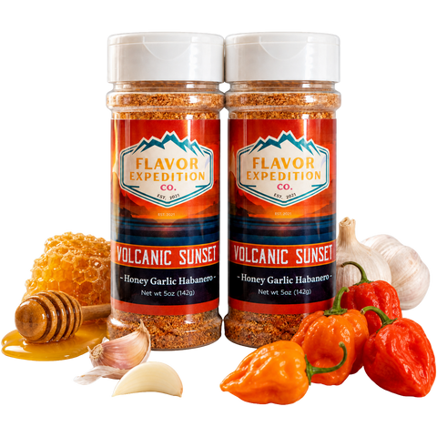 Two jars of Flavor Expedition Volcanic Sunset seasoning with peppers, garlic, and honey on a white background.