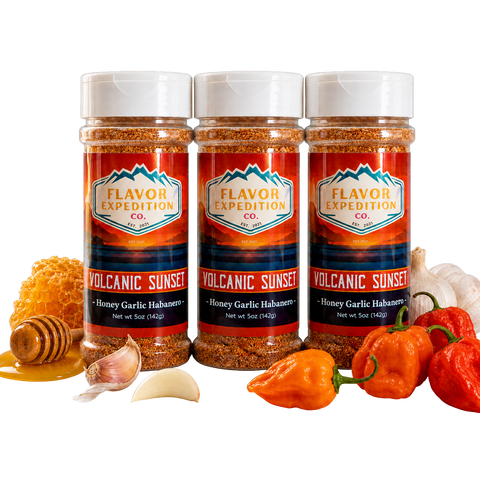 Three bottles of Flavor Expedition Co. Volcanic Sunset seasoning with peppers, garlic, and honey on a white background.