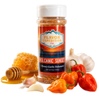 Spice jar labeled 'Flavor Expedition Co. Volcanic Sunset' with peppers, garlic, and honey on a white background
