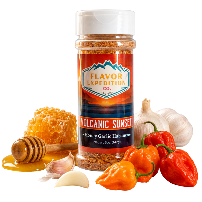 Spice jar labeled 'Flavor Expedition Co. Volcanic Sunset' with peppers, garlic, and honey on a white background