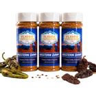 Three bottles of Flavor Expedition Co. Western Dawn Green Chile Chipotle seasoning with peppers and raisins on a white background.