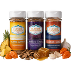 Three jars of Flavor Expedition Co. spices with ingredients like pineapple, garlic, and peppers on a white background.