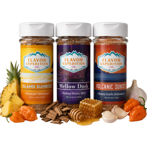 Three jars of Flavor Expedition Co. spices with ingredients like pineapple, garlic, and peppers on a white background.