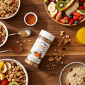 Bowl of cereal with fruit and a bottle of Flavor Creation seasoning on a wooden table.