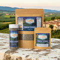 Tangy Herb Seasoning - Tuscan Evening bottles displayed against a scenic Tuscan landscape.