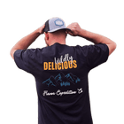 Man wearing a Wildly Delicious T-Shirt from Flavor Expedition Co. showcasing a vibrant logo.