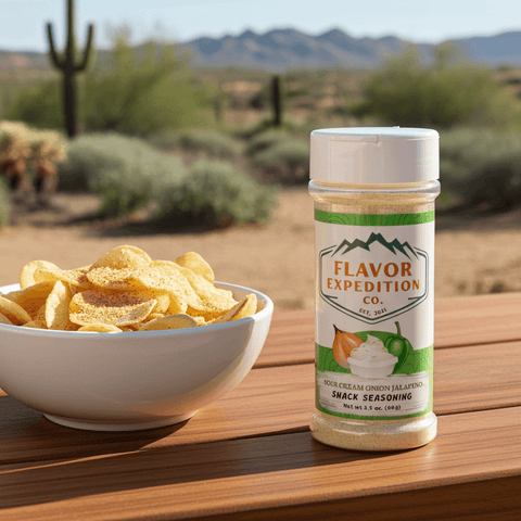 Bowl of chips with a jar of Flavor Expedition Co. seasoning on a wooden surface with desert landscape in the background